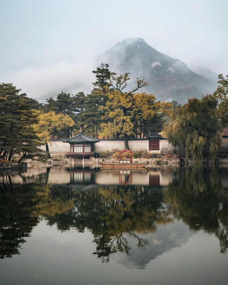A traditional house beside trees and water in Seoul